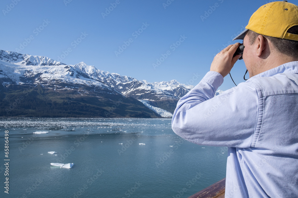 Man Looking at Mountains with a Binoculars