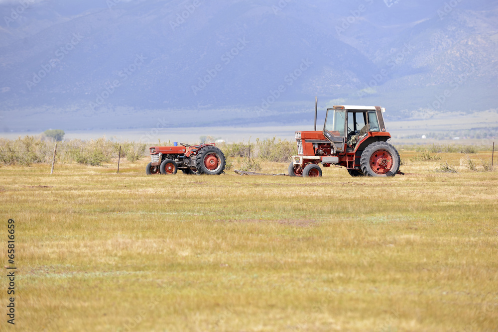 Tractor on farm in rural landscape Tractor on farm in rural landscape