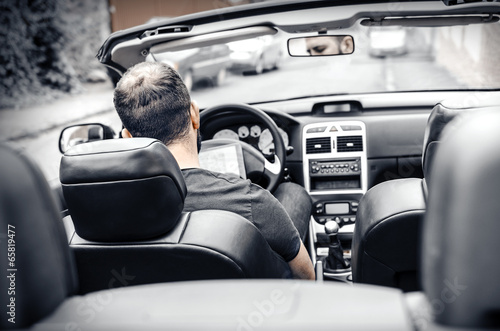 Car driver with the Tablet PC © Denis Rozhnovsky
