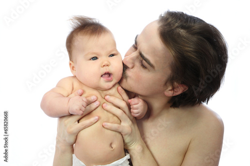 Daddy kissing newborn child