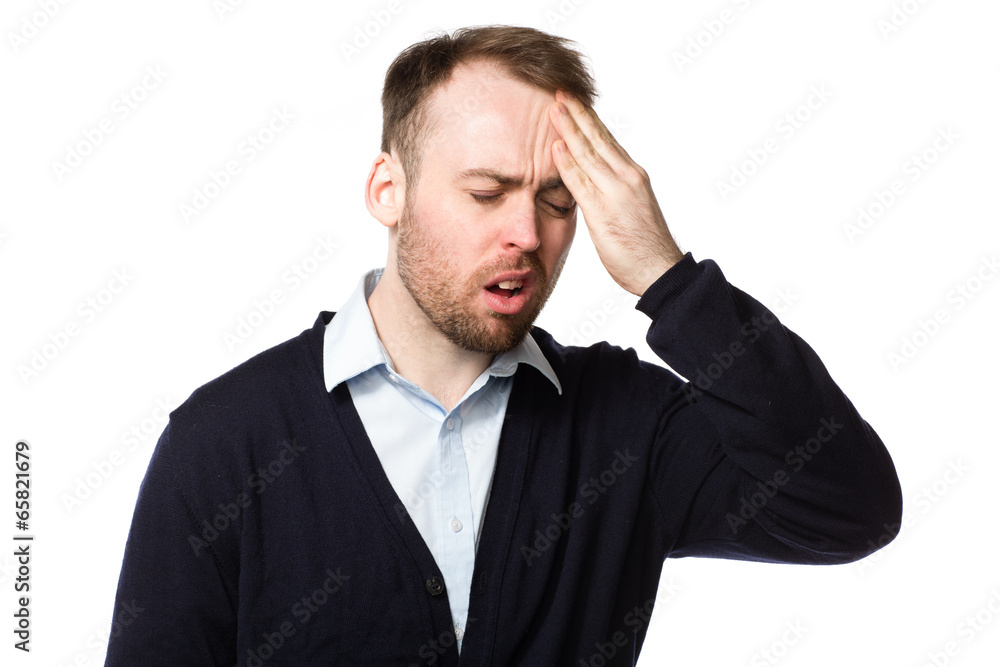 Man rubbing his throbbing forehead with his hand Man rubbing his throbbing forehead with his hand
