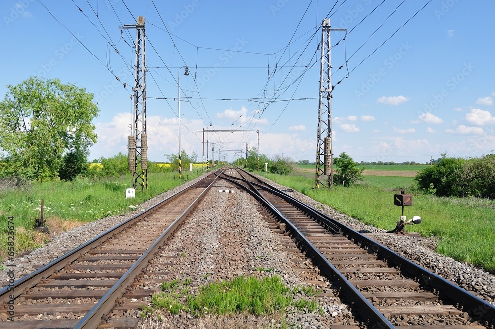 Two railway tracks in a rural scene