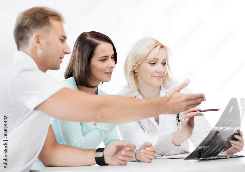 doctor with patients looking at x-ray doctor with patients looking at x-ray