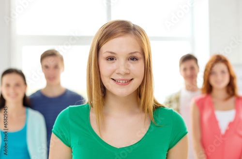 smiling students with teenage girl in front