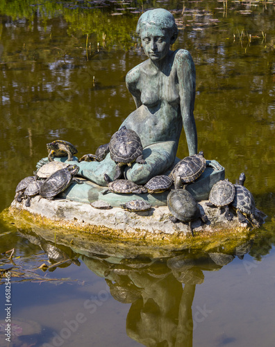 group of turtles in the sun on a statue