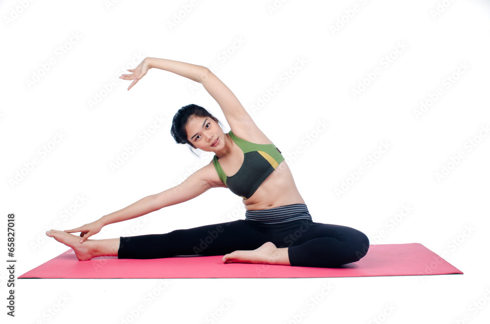 Beautiful woman indoor exercising using pink yoga mat Beautiful woman indoor exercising using pink yoga mat