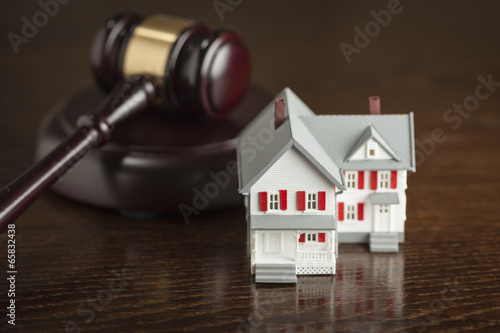 Gavel and Small Model House on Table photo