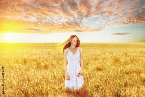 Beautiful young woman in wheat field