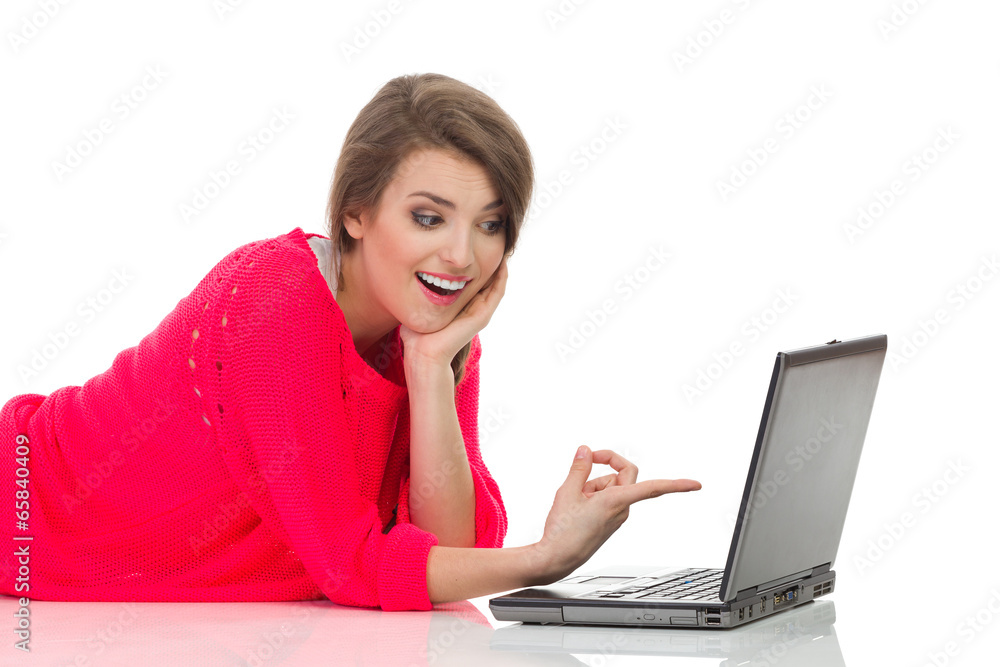 Beautiful girl pointing at laptop screen Beautiful girl pointing at laptop screen