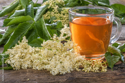 Domestic healthy elder  tea on a rustic wooden table