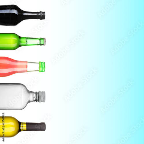 Collage of different alcohol bottles on blue background © Africa Studio