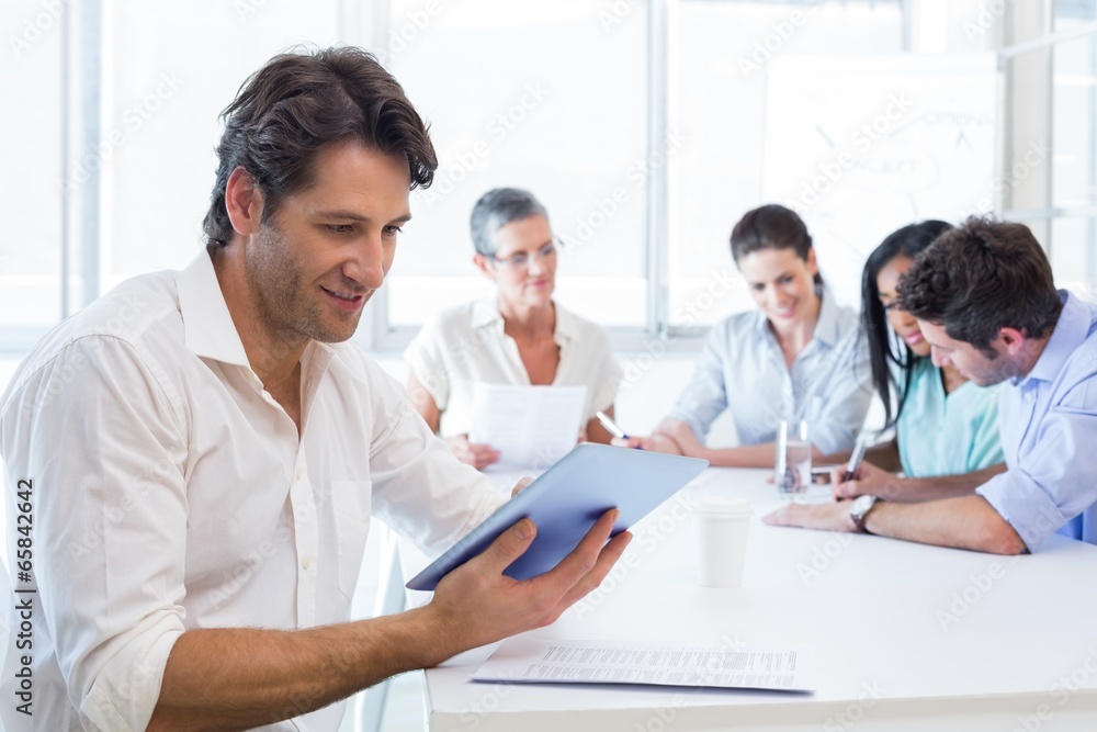 Attractive businessman using tablet at work Attractive businessman using tablet at work