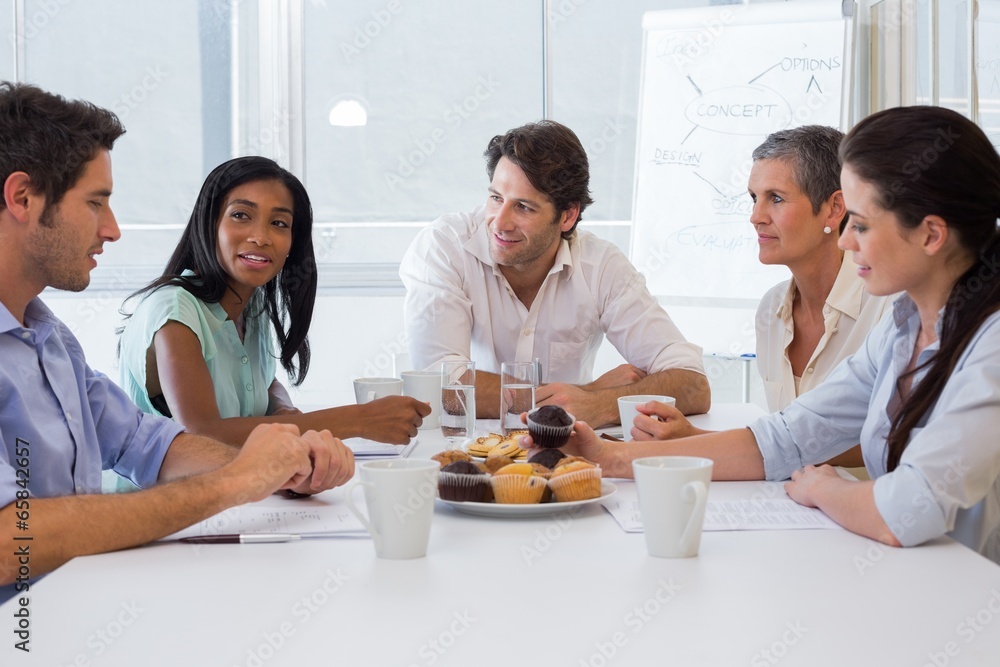 Workers working while enjoying hot drinks and muffins Workers working while enjoying hot drinks and muffins