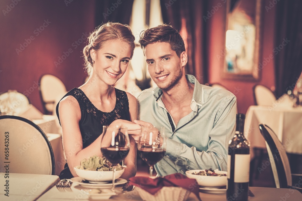 Couple with glasses of red wine in luxury restaurant