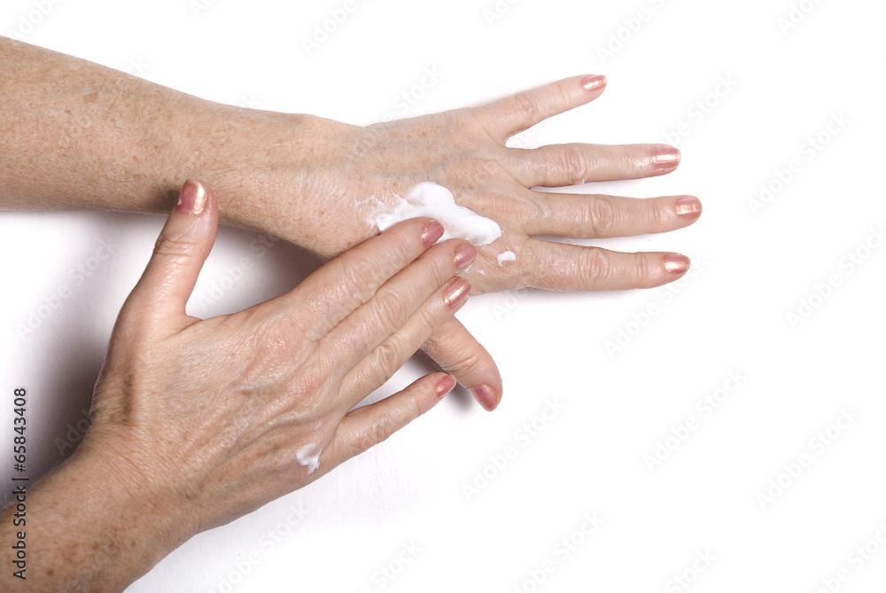 Fototapeta premium Mature woman applying cream