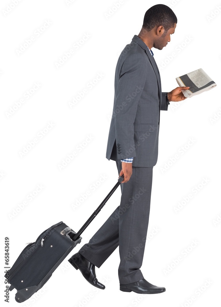 Young businessman pulling his suitcase Young businessman pulling his suitcase