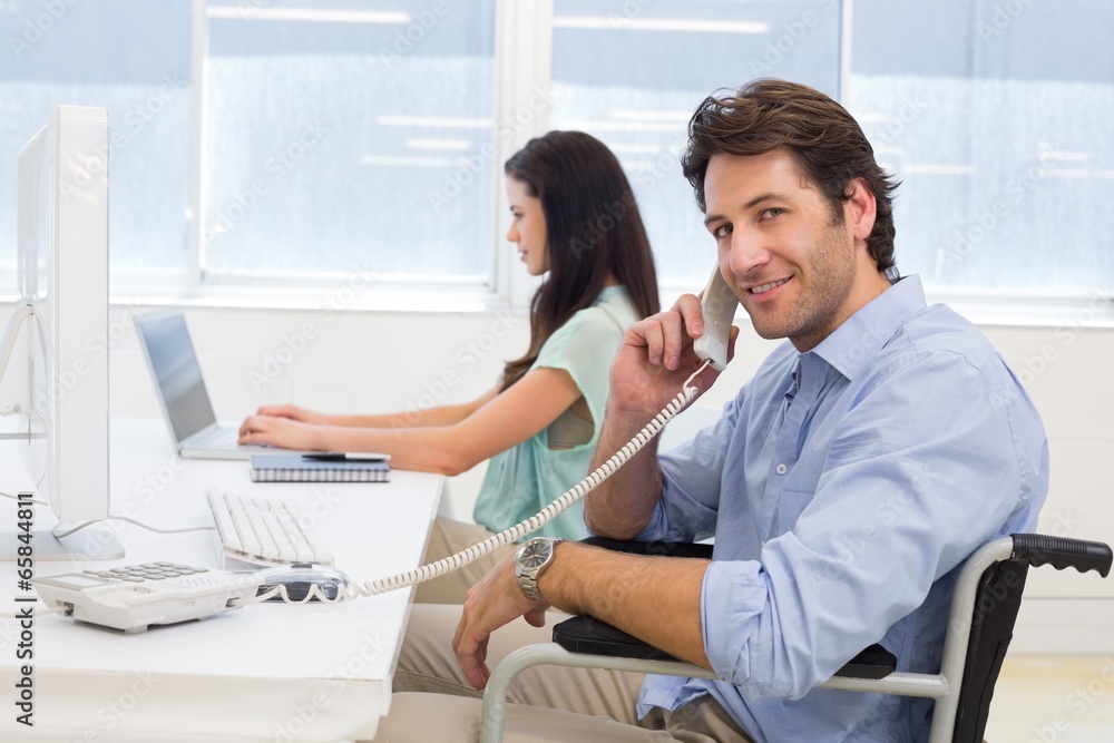Obraz premium Businessman in wheelchair on telephone