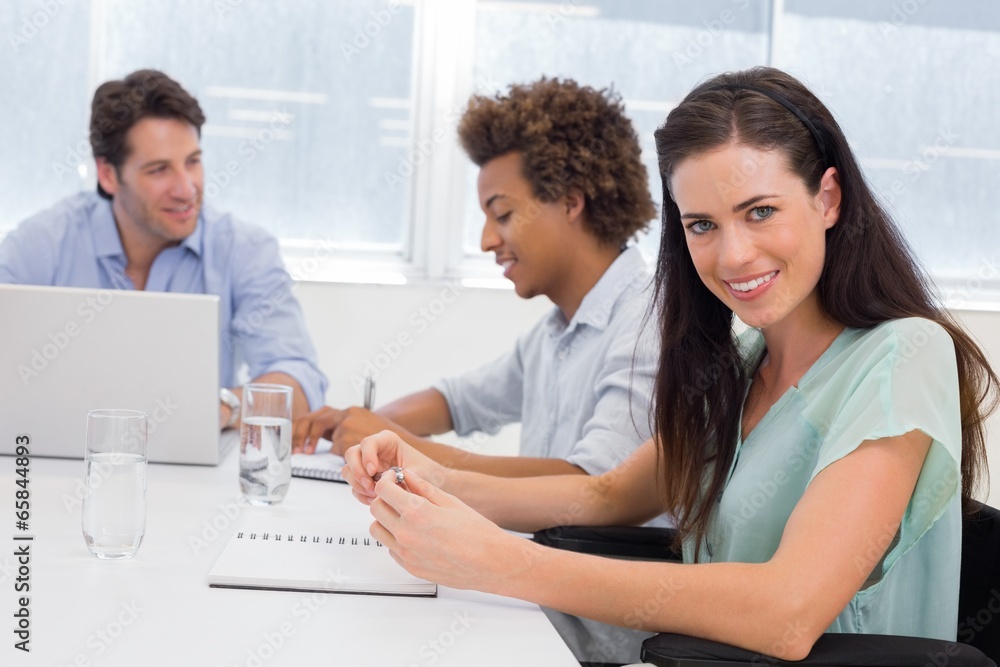 Casual businesswoman smiling at camera during meeting Casual businesswoman smiling at camera during meeting