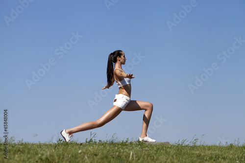 Fitness woman exercising in summer park