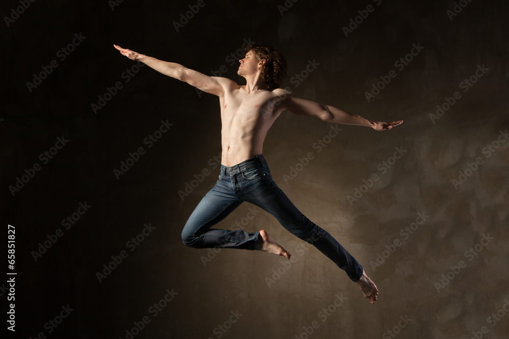 Young and stylish modern dancer on grey background