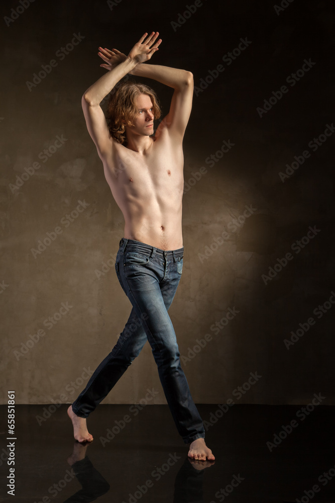 Young and stylish modern dancer on grey background