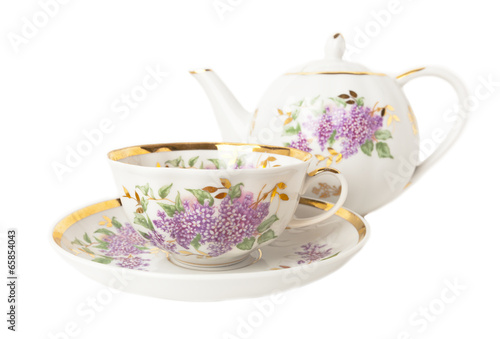 Porcelain teapot, teacup and saucer on white