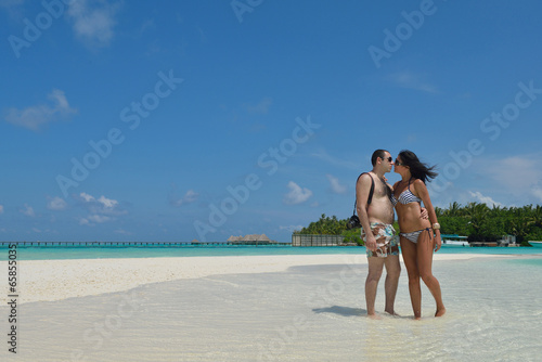 happy young couple have fun on beach