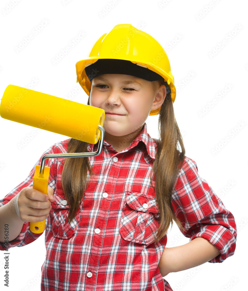 Girl as a construction worker with paint roller Girl as a construction worker with paint roller