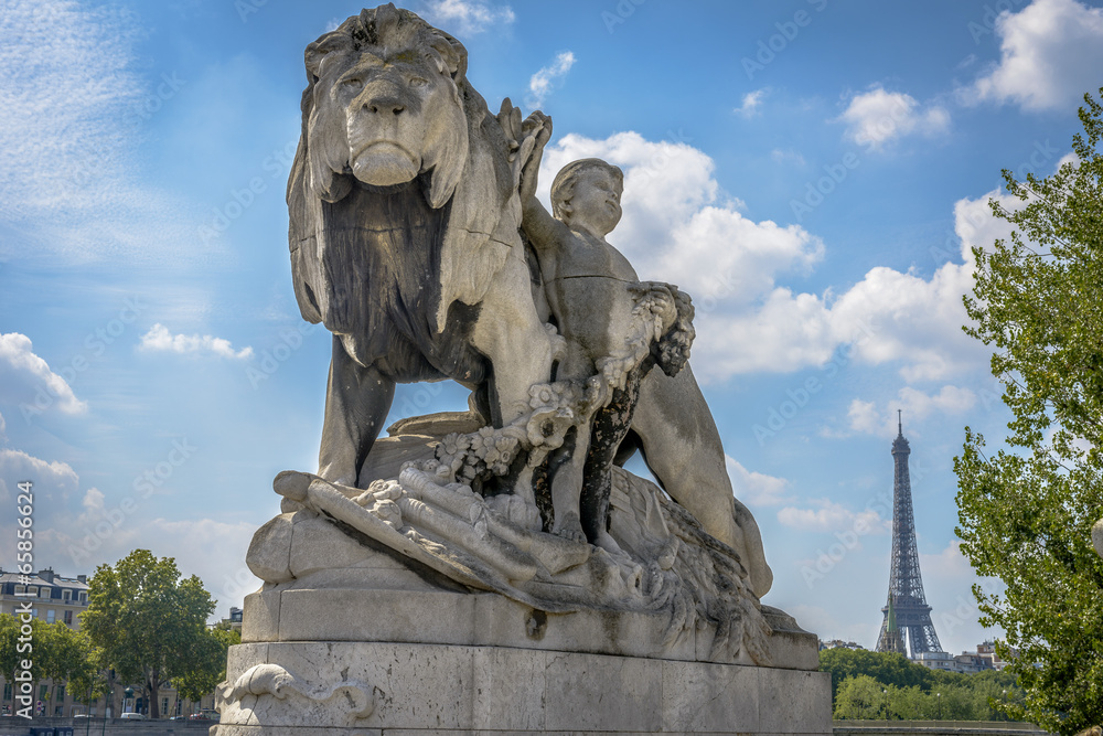 Eiffel Tower view and a statue from Pont Alexandre III