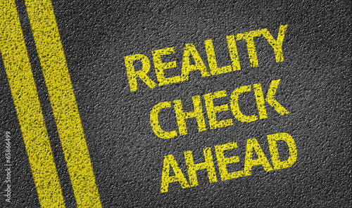 Reality Check Ahead written on the road