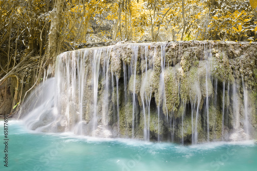 Waterfall  green forest in Erawan National Park  Thailand. Landscape with water flow  river  stream and rock at outdoor. Beautiful scenery of nature for tourist to tour  visit  relax in vacation.