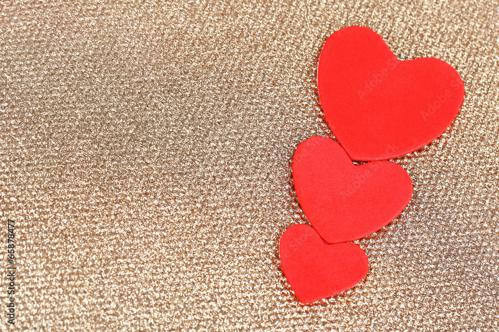 Hearts made of felt on golden background Hearts made of felt on golden background