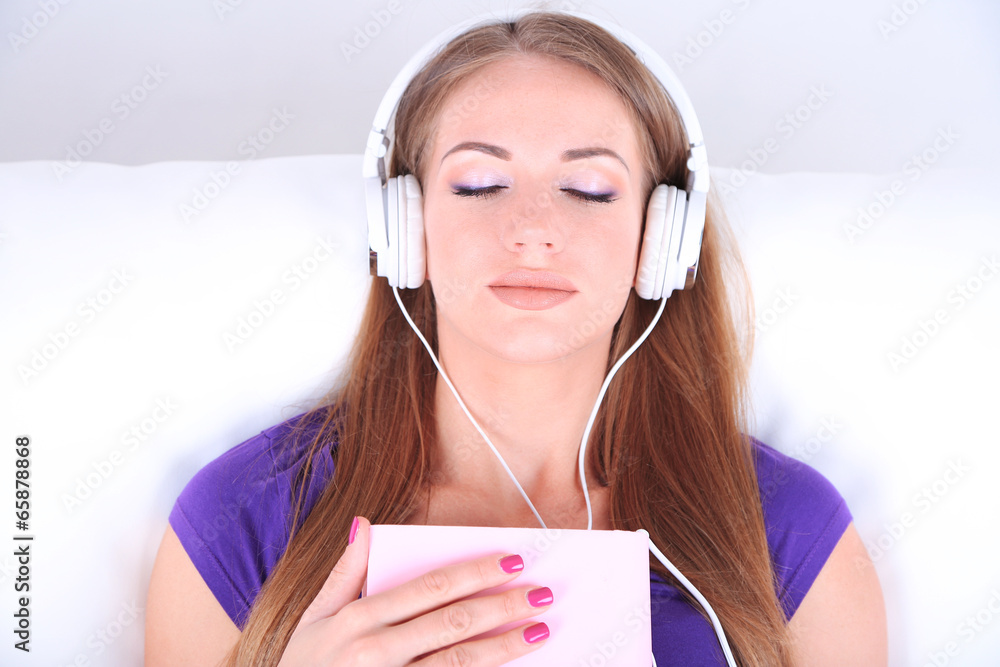 Conceptual image of  audio book.Beautiful girl with book and