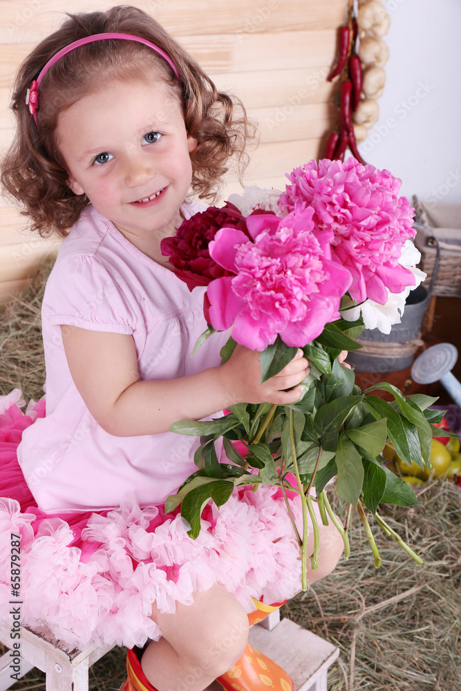 Beautiful small girl in petty skirt holding flowers Beautiful small girl in petty skirt holding flowers