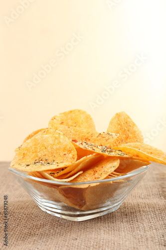 Homemade potato chips in glass bowl on table