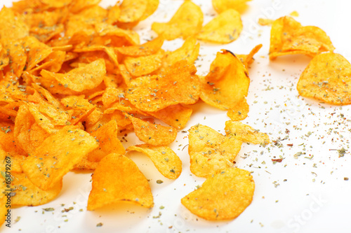 Homemade potato chips isolated on white