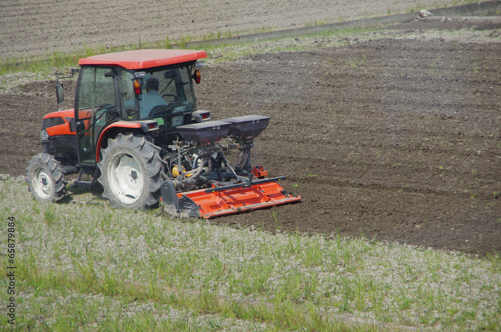 Fototapeta premium tractor plowing a field