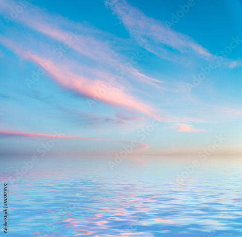 Dramatic sunset with clouds reflected in water. © Vladimir Arndt