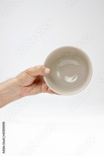 Hungry man holding empty bowl