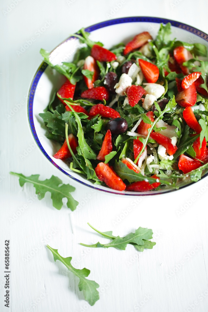 Rocket salad with strawberries, kalamata olives and goat cheese Rocket salad with strawberries, kalamata olives and goat cheese