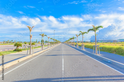 Asphalt road and blue sky with clouds