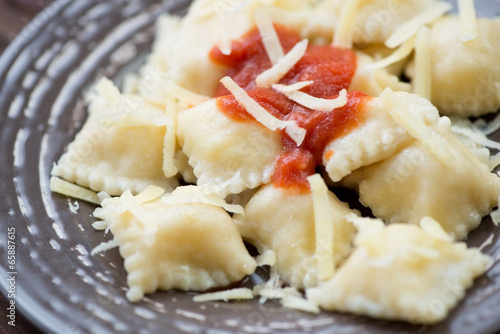 Close-up of cheese ravioli with tomato sauce, horizontal shot