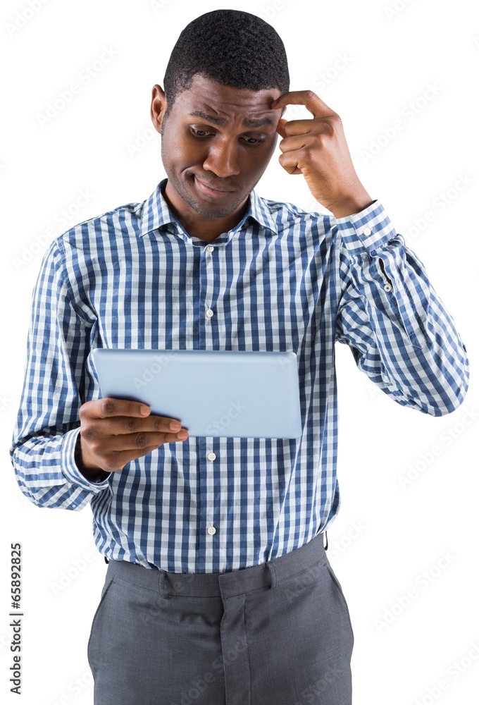 Young businessman thinking and holding tablet Young businessman thinking and holding tablet