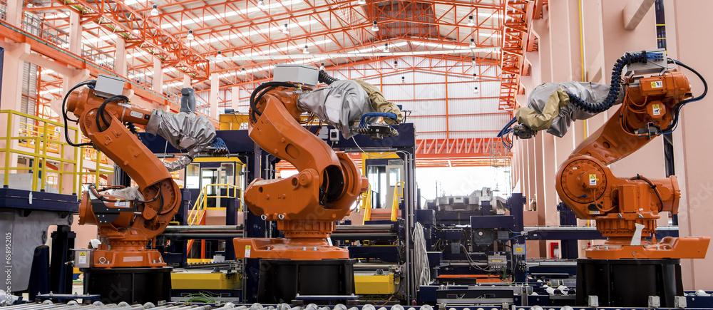 Robots welding in a production line - obrazy, fototapety, plakaty 