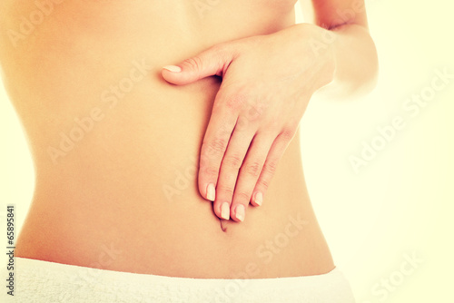 Hand on slim woman belly