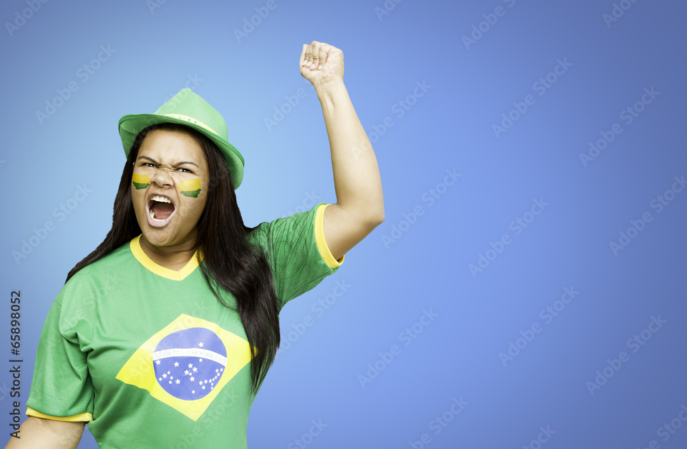 Brazilian fan celebrates on blue background Brazilian fan celebrates on blue background