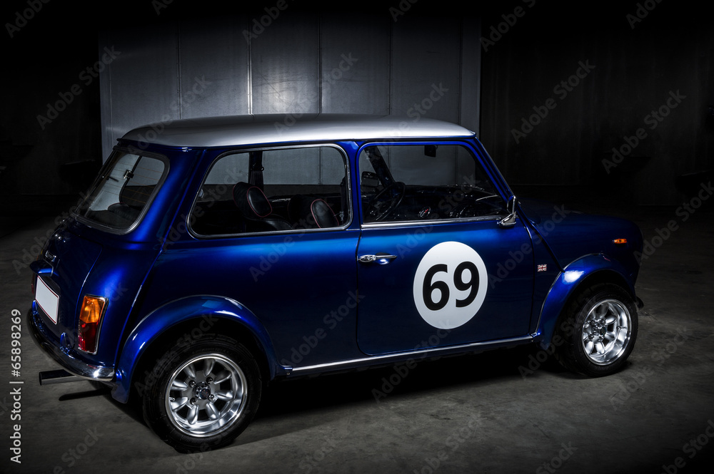 Iconic blue Mini Cooper in a parking area - obrazy, fototapety, plakaty 