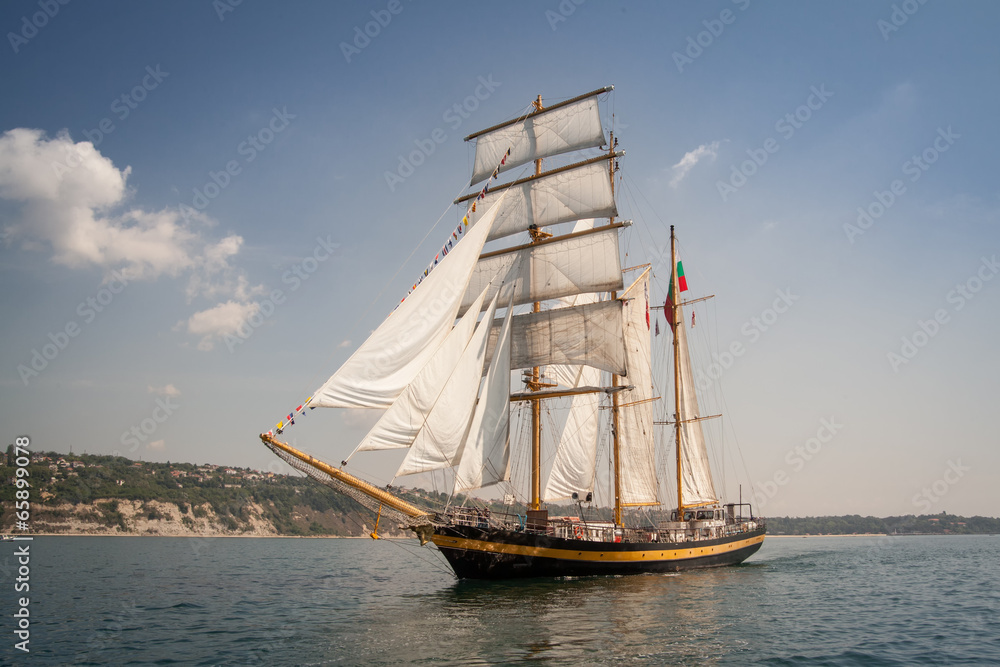 Old ship with white sales, sailing in the sea Old ship with white sales, sailing in the sea
