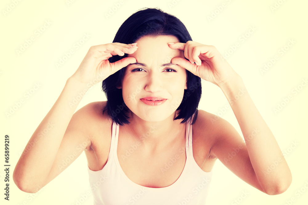 Beautiful shocked woman checking her wrinkles Beautiful shocked woman checking her wrinkles