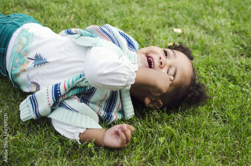 Outdoor portrait of a cute young black baby girl